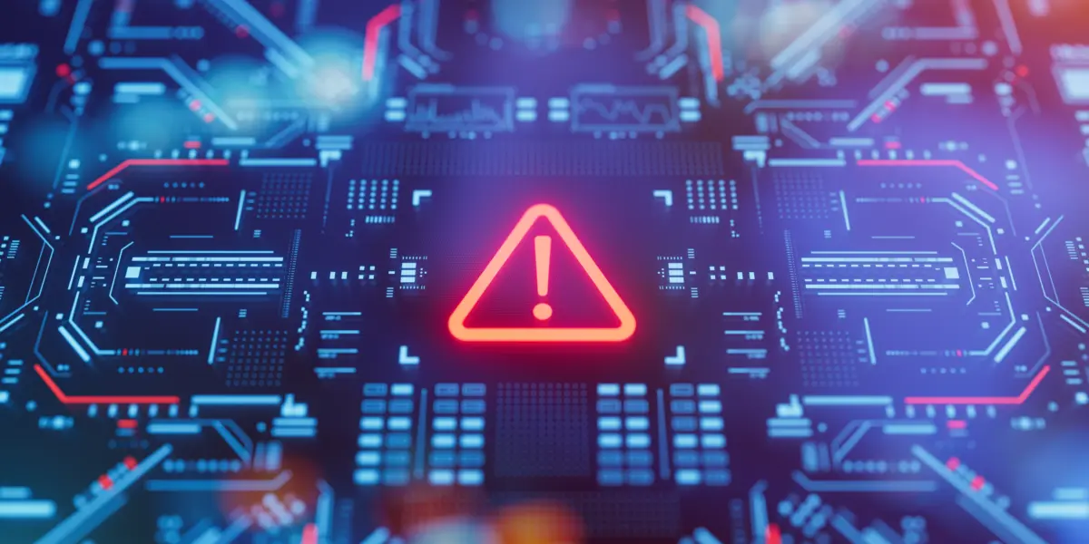 Warning icon on a digital LCD display with reflection. Concept of cyber attack, malware, ransomware, data breach, system hacking, virus, spyware, compromised information and urgent attention.